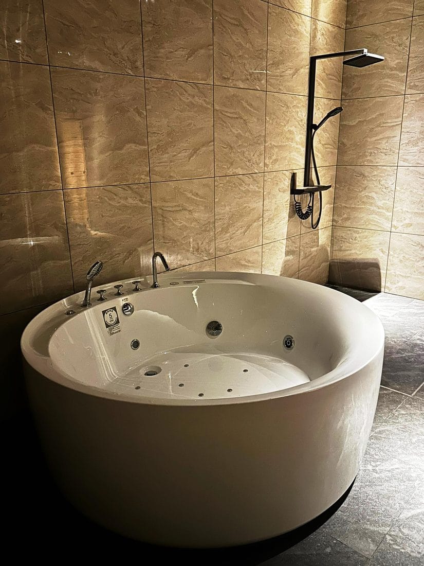 A private marble jacuzzi suite with rainfall shower at Rexury Wellness Centre