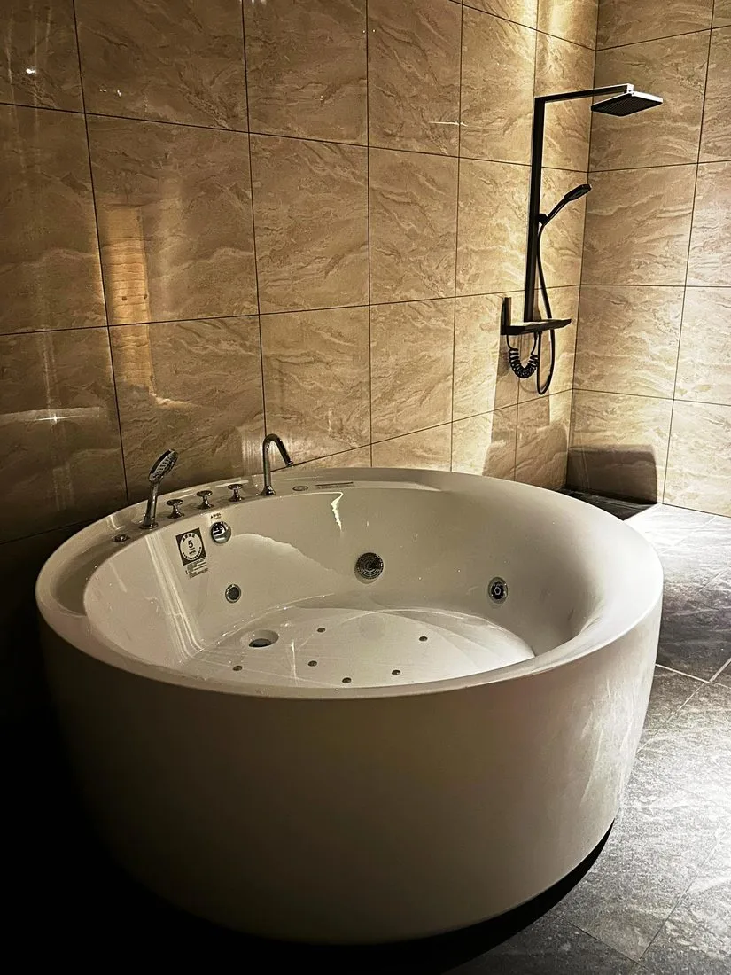 A private marble jacuzzi suite with rainfall shower at Rexury Wellness Centre
